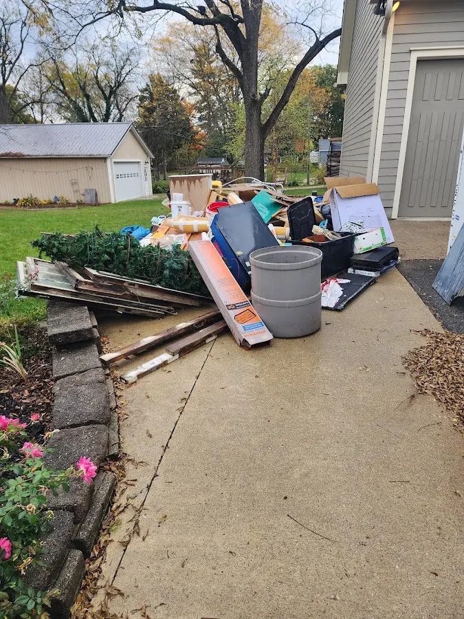 Dumpster being loaded with debris for Roofing Dumpster Rental in Dunlap